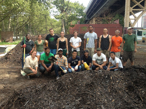 compost workers by pile