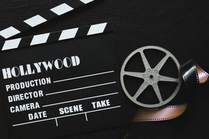 a-movie-clapper-board-film-roll-and-sprocket-wheel