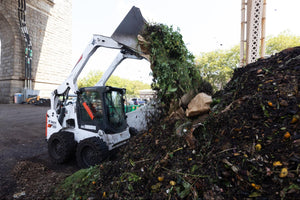 Skid steer turning compost piles